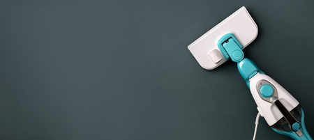 Steam cleaner mop on grey background. Top view, flat lay. Banner with copy space. Cleaning service...
