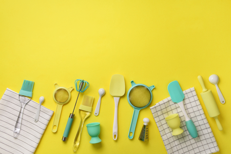 Time to cook. Turquoise cooking utensils on yellow background. Food ingredients. Cooking cakes and baking bread concept. Copy space. Top view. Flat lay.の写真素材