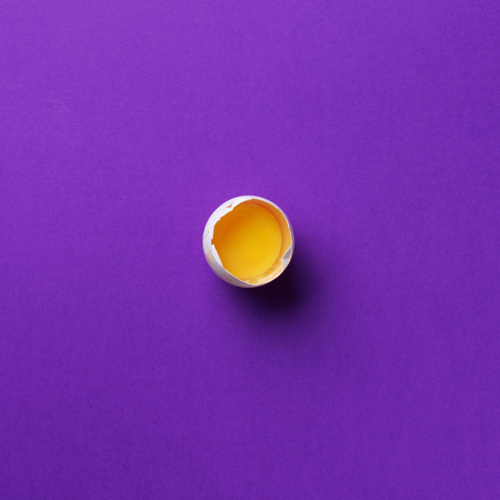 Food concept with one white egg on violet background. Top view. Creative pattern in minimal style....