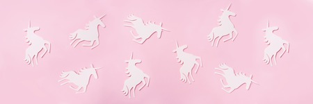 Creative unicorn pattern on pink background. Abstract art texture Minimal fantasy concept. Banner. Top view.の写真素材