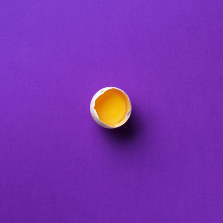 Food concept with one white egg on violet background. Top view. Creative pattern in minimal style....