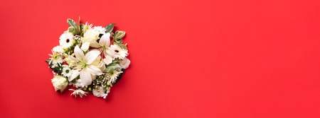 Circle of white flowers over paper red background. Valentines day, Woman day concept. Spring or...