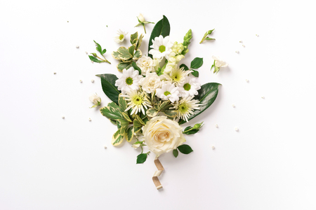 Spring composition of white flowers on light paper background with copy space. Creative layout. Flat lay. Top view. Summer minimal conceptの写真素材