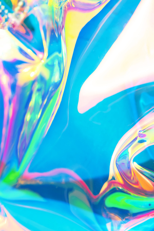 Neon holographic background. Wallpaper hologram with copy space. Wrinkled abstract texture with multiple colorsの写真素材