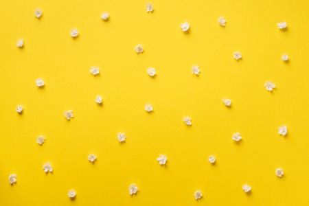 Daisy pattern. Top view. Flat lay. Floral pattern of white chamomile flowers on yellow background. Summer concept.の写真素材