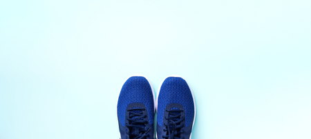 Pair of sport shoes on blue background. Top view, copy space. Fitness, running and sport concept. Healthy lifestyle. Banner.の写真素材
