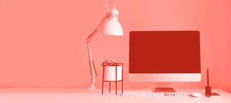 Designer workspace on trendy coral color background. Minimalistic home office. Copy space. Keyboard, mouse, computer display with black blank screen. Front viewの写真素材
