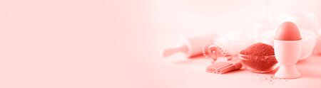 Healthy baking ingredients - butter, sugar, flour, eggs, oil, spoon, brush, whisk, milk in trendy coral color background. Banner. Bakery food frame, cooking concept.の写真素材