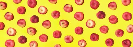 Peaches pattern on pastel yellow background. Frame made of fresh fruits. Flat lay, top view, copy space. Vegan and vegetarian diet. Banner.の写真素材