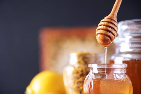 Ingredients for healthy hot drink. Lemon, ginger, mint, honey, apple and spices on dark background. Copy space. Alternative medicine concept. Clean eating, detox.の写真素材