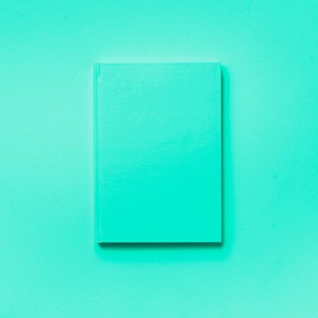 Top view of open mint notebook on trendy green and turquoise color. Copy space. Woman business, study, back to school concept. Time managenet, to do list.の写真素材