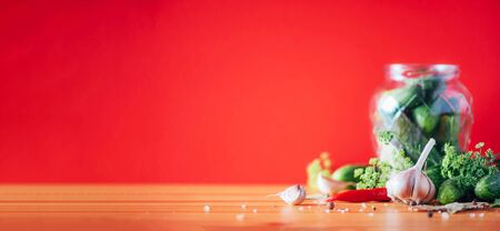 Pickling cucumbers in cans. Ingredients for marinated gherkins, glass jar, garlic, dill, salt,...