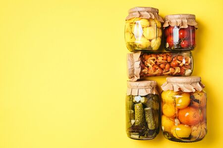 ?ucumber, squash and tomatoes pickling and canning into glass jars. Ingredients for vegetables preserving. Healthy fermented food concept. Top view. Copy spaceの写真素材