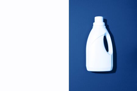 White plastic bottle of cleaning product, household chemicals or liquid laundry detergent on classic blue background. Top view. Flat lay. Copy space. Detergent bottle.の写真素材