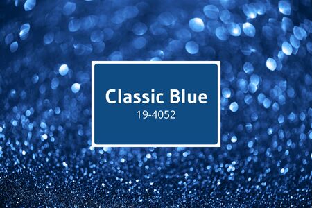Holiday abstract texture. Christmas card with copy space. ?lassic blue background bokeh, defocused lightsの写真素材
