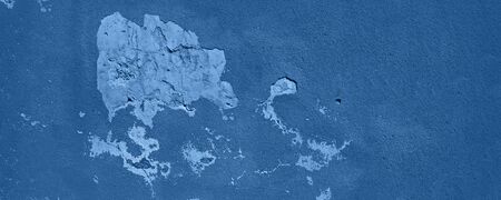 Old cracked monochrome wall. Painted texture background in trendy calm color. Banner. Biscay Green...