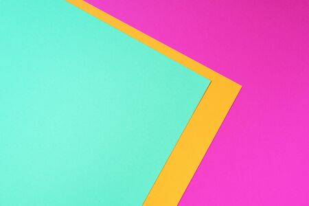 Colorful trendy green, pink and yellow paper background. Top view. Copy spaceの写真素材