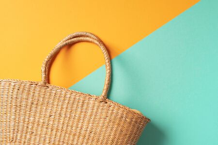 Womens straw bag on trendy yellow and green background. Top view. Copy space. Summer travel concept. Sustainable lifestyle. Zero waste, plastic free concept.の写真素材