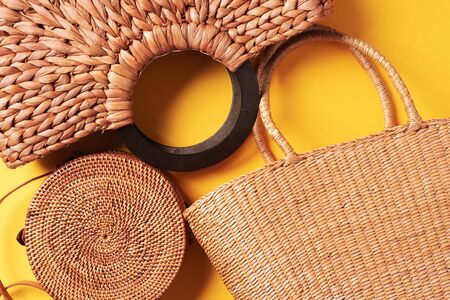 Set of womens straw bags on trendy yellow background. Top view. Copy space. Summer travel concept. Sustainable lifestyle. Zero waste, plastic free concept.の写真素材