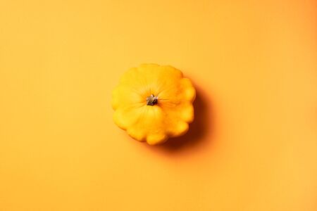 Natural orange organic pumpkin on trendy yellow background. Top view. Copy space. Autumn harvest...