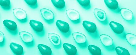 Avocado pattern on mint color background. Top view. Trendy green and turquoise color. Pop art...