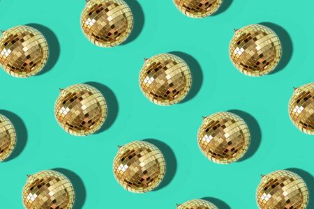 New year baubles. Shiny gold disco balls on mint background. Pop disco style attributes, retro...