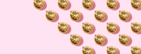 New year baubles. Shiny gold disco balls on pink background. Pop disco style attributes, retro concept. Creative Christmas pattern. Flat lay, top viewの写真素材