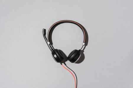 Style black headphones on grey background. Top view. Copy space. Music and sound concept. Urban...