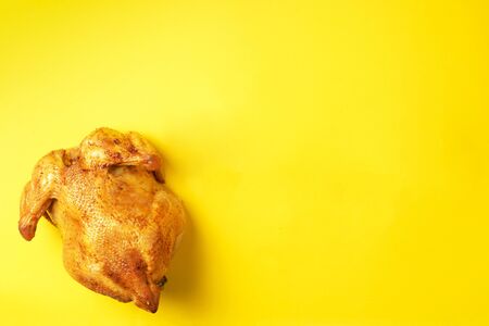 Food pattern. Roast whole turkey or chicken on yellow background. Top view. Festive family dinner....