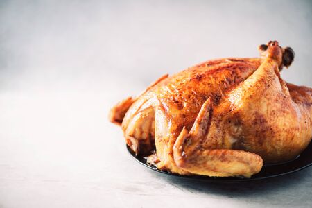 Whole roasted chicken in baking dish. Top view. Copy space. Macro shoot