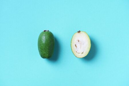 Tropical fruit feijoa on blue background. Top view. Copy space. Acca sellowiana. Creative design...