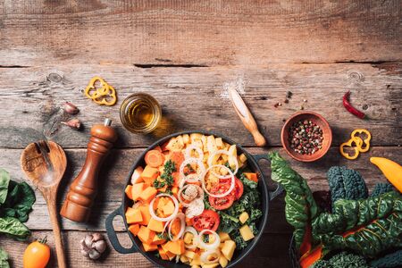 Organic vegetarian ingredients and kitchen tools. Healthy, clean food and eating concept. Top view. Copy space. Ingredients for cooking on wooden table. Vegan diet concept with copyspace. Zero waste.の写真素材