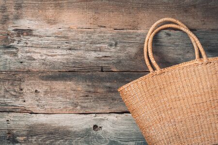 Handmade summer bag on wooden background. Top view. Fashionable stylish accessory. Natural, organic, eco friendly, zero waste, plastic free conceptの写真素材