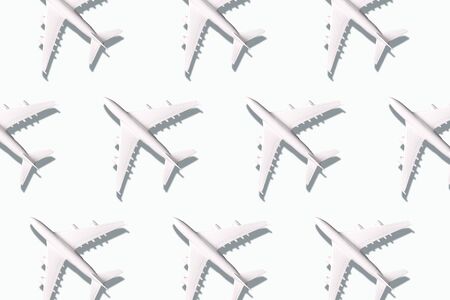Summer pattern. Creative banner of planes on white background. Travel, vacation concept. Travel, vacation ban. Flights cancelled and resumed again. Top view. Flat lay. Minimal style designの写真素材