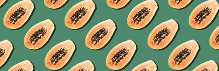 Seamless pattern with papaya. Tropical abstract background. Top view. Creative design, minimal flat lay concept. Summer time. Tropical travel, exotic papaya fruit. Vegan and vegetarian food.の写真素材
