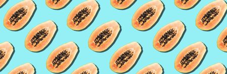 Seamless pattern with papaya. Tropical abstract background. Top view. Creative design, minimal flat lay concept. Summer time. Tropical travel, exotic papaya fruit. Vegan and vegetarian food.の写真素材