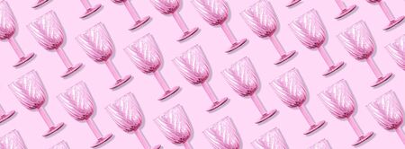 Champagne glass pattern on pink background with copy space for text. Top view. Holiday and celebration concept. Packing design. Creative design, minimal flat lay conceptの写真素材