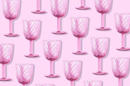 Champagne glass pattern on pink background with copy space for text. Top view. Holiday and celebration concept. Packing design. Creative design, minimal flat lay conceptの写真素材
