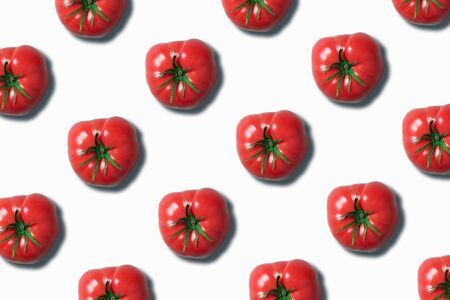 Red tomato pattern on white background with copy space. Top view. Flat lay. Creative packing design. Summer minimal concept. Vegan and vegetarian diet.の写真素材
