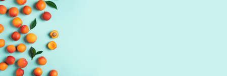 Apricot pattern on blue background. Top view, flat lay. Fresh summer fruit concept. Creative design....