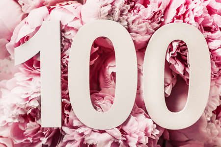 Peony flowers, digit one hundred. Birthday greeting card with inscription 100. Anniversary concept. Top view. White numeral on flower background. Numerical digit, Celebration event, template, flyerの写真素材