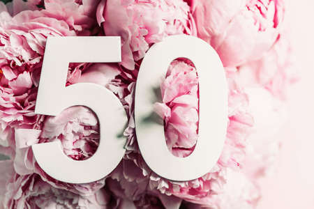 Peony flowers, digit fifty. Birthday greeting card with inscription 50. Anniversary concept. Top view. White numeral on flower background. Numerical digit, Celebration event, template, flyerの写真素材