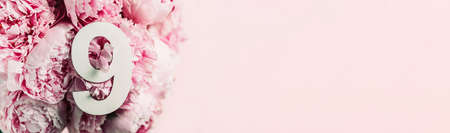 Creative layout. Pink peony flowers and digit nine 9. Birthday greeting card. Anniversary concept....