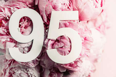 Peony flowers, digit ninety-five. Birthday greeting card with inscription 95. Anniversary concept. Top view. White numeral on flower background. Numerical digit, Celebration event, template, flyerの写真素材
