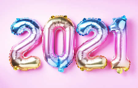 Colorful foil balloons made numbers 2021 on pink background with light bokehs. Banner, copy space. Happy new year celebration party. Greetings and congratulation conceptの写真素材