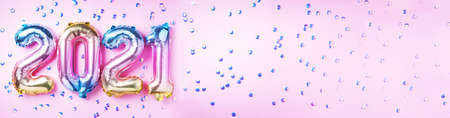 Colorful foil balloons made numbers 2021 on pink background with light bokehs. Banner, copy space. Happy new year celebration party. Greetings and congratulation conceptの写真素材