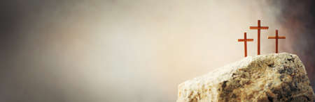 Silhouette of three crosses on Calvary hill, grey background.の写真素材