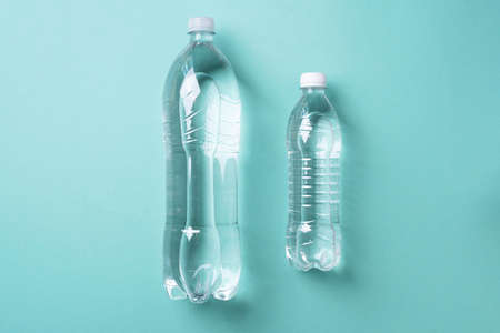 Water balance. Pure water in bottle for healthy lifestyle on blue background. Top view. Copy space. World water day. Pollution, environmental protection concept. Global water crisis and problemの写真素材