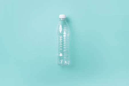 Empty rumpled used plastic bottle on blue background. Top view, copy space. Pollution, environmental protection concept. Reuse garbage, recycle, plastic free. Earth, world water dayの写真素材