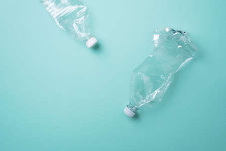 Plastic empty rumpled bottles on a blue background. Top view, copy space. Zero waste. Pollution,...